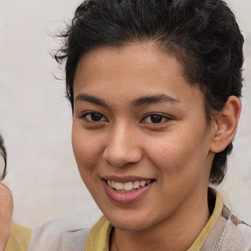 Joyful latino young-adult female with short  brown hair and brown eyes