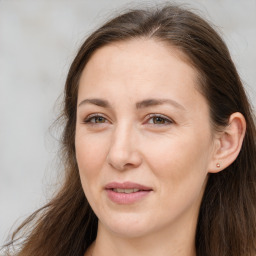 Joyful white adult female with long  brown hair and brown eyes