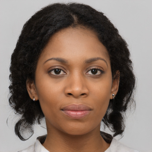 Joyful black young-adult female with medium  brown hair and brown eyes