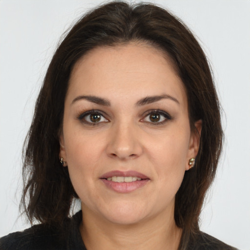 Joyful white adult female with long  brown hair and brown eyes