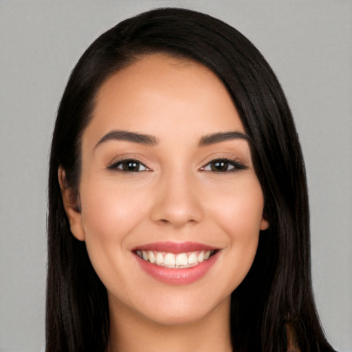 Joyful white young-adult female with long  black hair and brown eyes