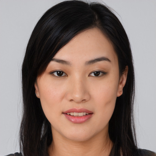 Joyful asian young-adult female with long  black hair and brown eyes