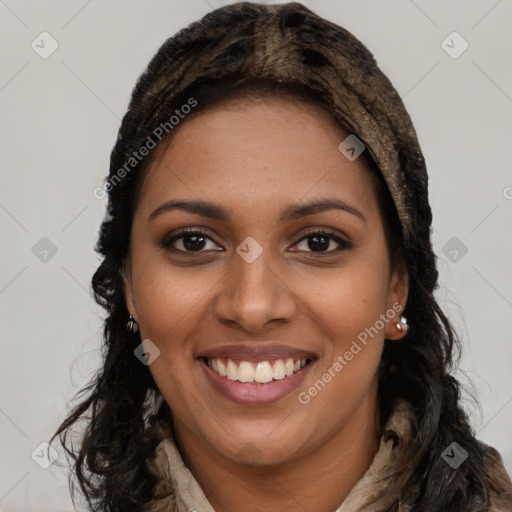 Joyful black young-adult female with long  brown hair and brown eyes