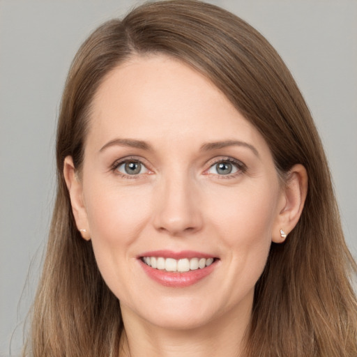 Joyful white young-adult female with long  brown hair and grey eyes