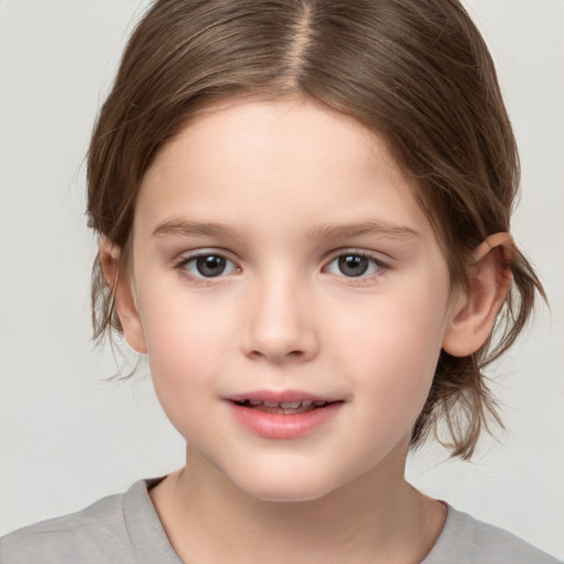 Joyful white child female with medium  brown hair and brown eyes