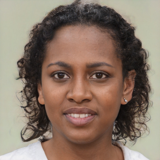 Joyful black young-adult female with medium  brown hair and brown eyes
