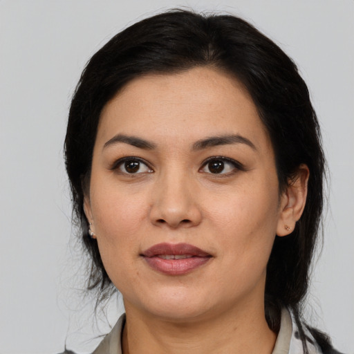 Joyful latino young-adult female with medium  black hair and brown eyes