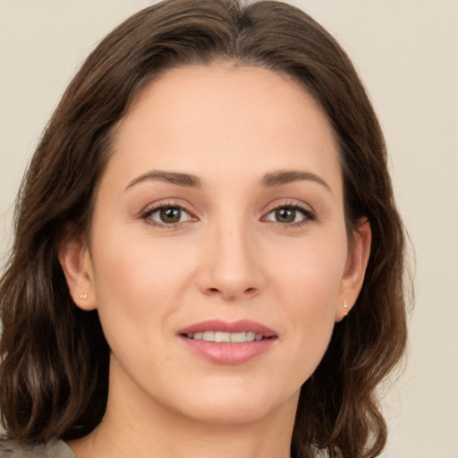 Joyful white young-adult female with medium  brown hair and green eyes