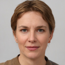 Joyful white adult female with medium  brown hair and grey eyes