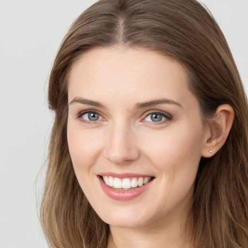 Joyful white young-adult female with long  brown hair and grey eyes