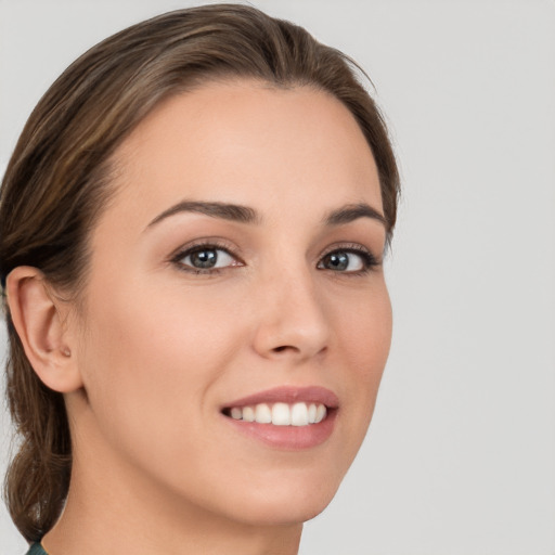 Joyful white young-adult female with medium  brown hair and brown eyes