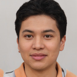 Joyful latino young-adult male with short  brown hair and brown eyes