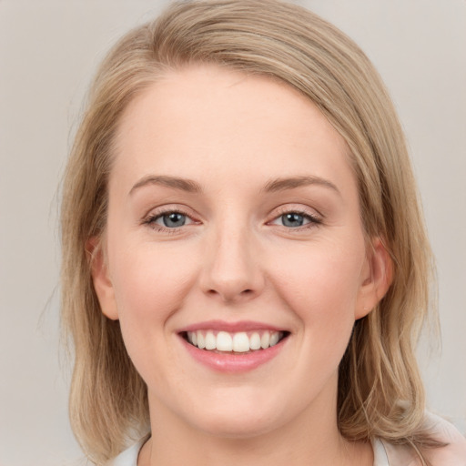 Joyful white young-adult female with medium  brown hair and blue eyes