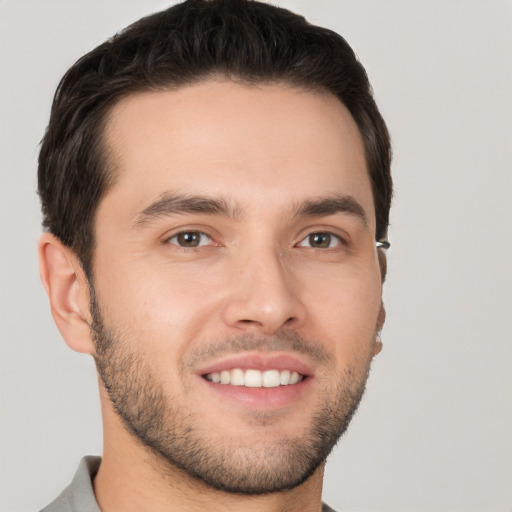 Joyful white young-adult male with short  brown hair and brown eyes