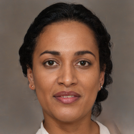 Joyful latino adult female with short  brown hair and brown eyes