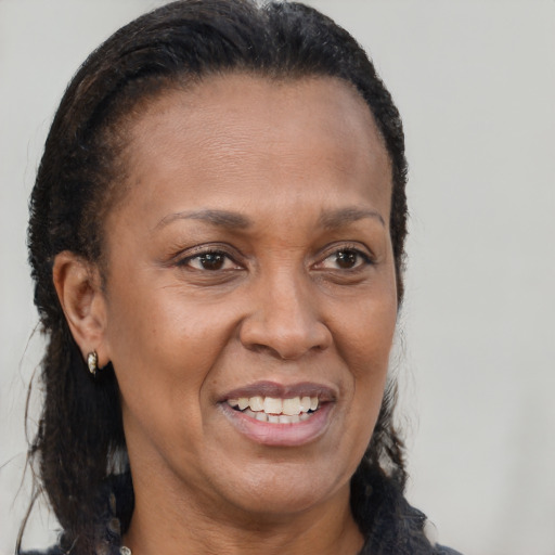Joyful latino adult female with long  brown hair and brown eyes