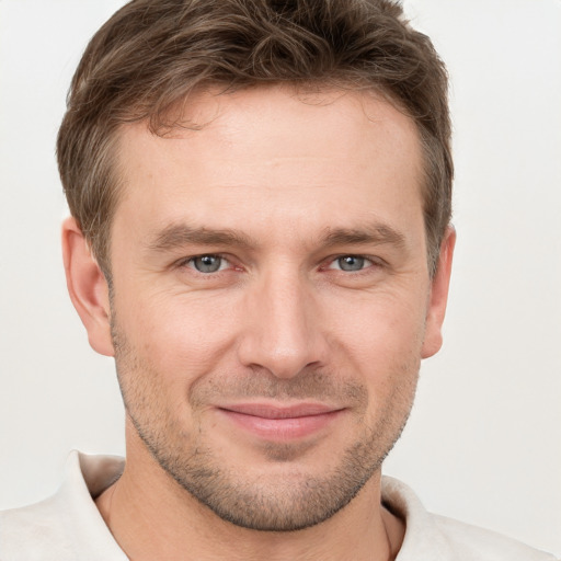 Joyful white adult male with short  brown hair and grey eyes