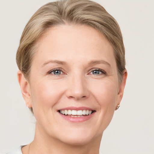 Joyful white adult female with short  brown hair and grey eyes