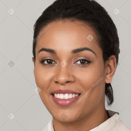 Joyful latino young-adult female with short  brown hair and brown eyes