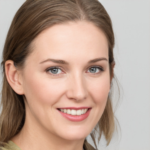 Joyful white young-adult female with medium  brown hair and blue eyes