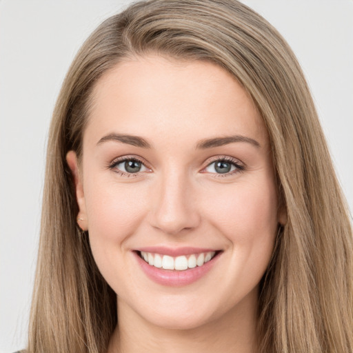 Joyful white young-adult female with long  brown hair and green eyes