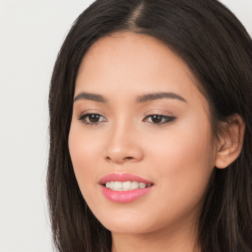 Joyful white young-adult female with long  black hair and brown eyes