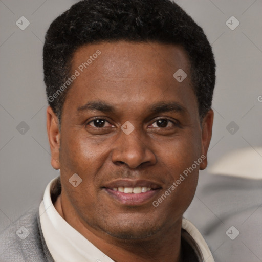 Joyful latino young-adult male with short  brown hair and brown eyes