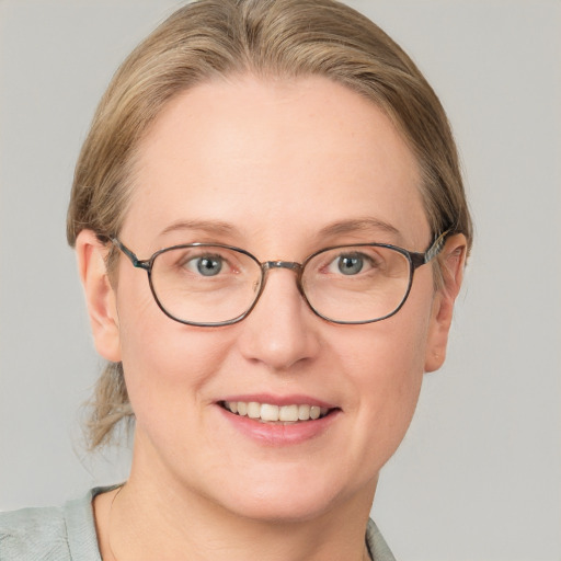 Joyful white adult female with short  brown hair and blue eyes