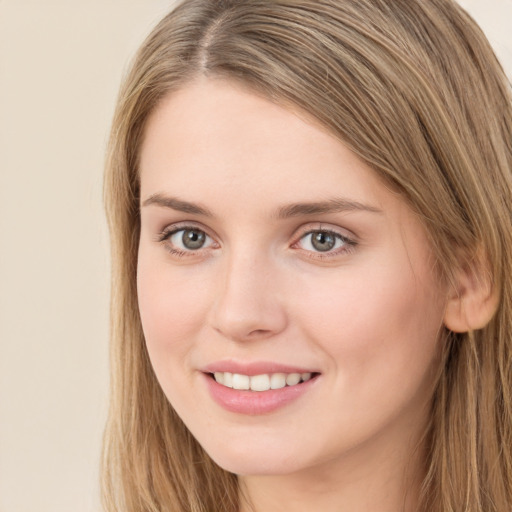 Joyful white young-adult female with long  brown hair and grey eyes