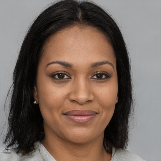 Joyful black young-adult female with medium  brown hair and brown eyes