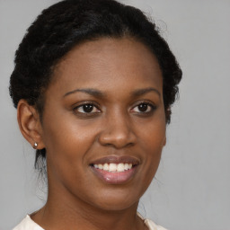 Joyful black young-adult female with short  brown hair and brown eyes