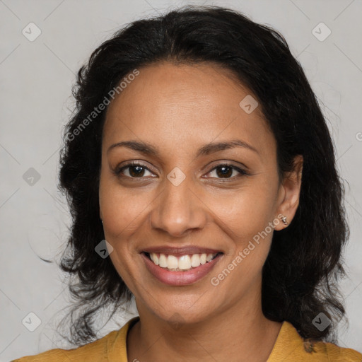 Joyful latino adult female with medium  brown hair and brown eyes