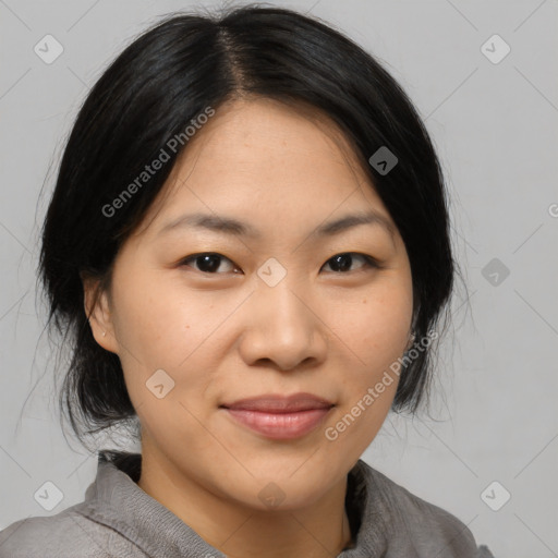 Joyful asian young-adult female with medium  black hair and brown eyes