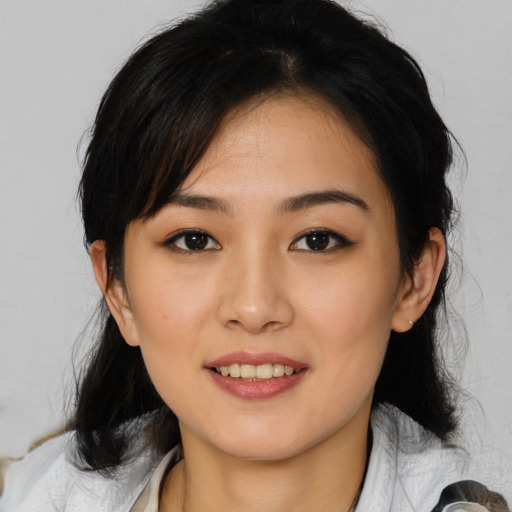 Joyful asian young-adult female with medium  brown hair and brown eyes