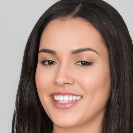 Joyful white young-adult female with long  black hair and brown eyes