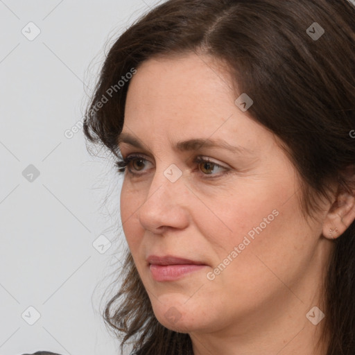 Joyful white adult female with medium  brown hair and brown eyes