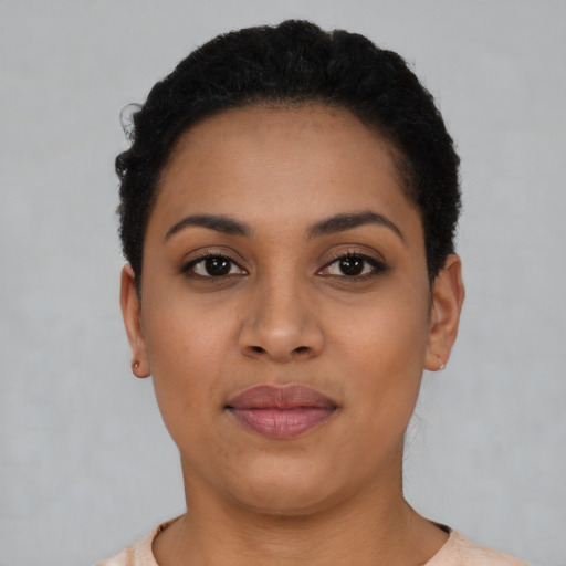 Joyful latino young-adult female with short  black hair and brown eyes