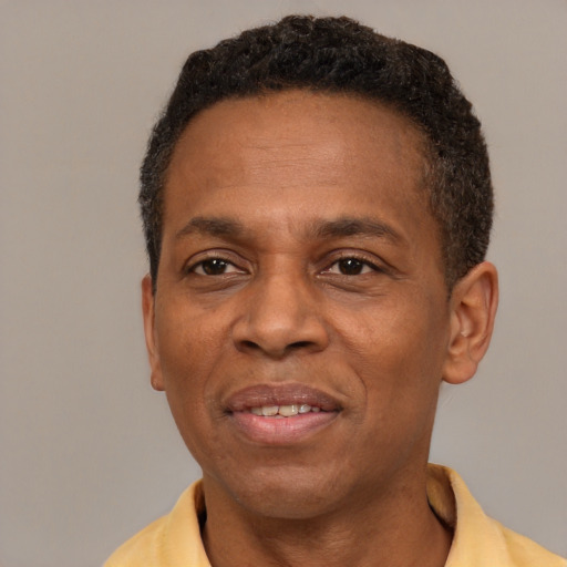 Joyful latino adult male with short  black hair and brown eyes
