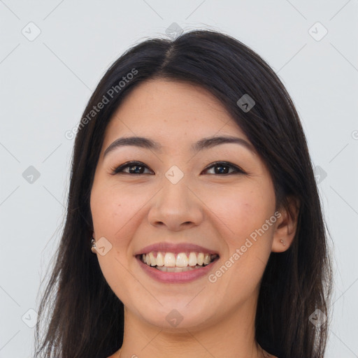 Joyful asian young-adult female with long  brown hair and brown eyes