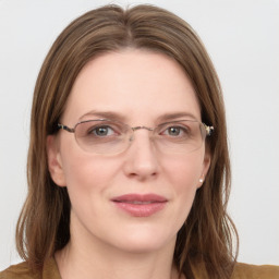 Joyful white young-adult female with medium  brown hair and blue eyes