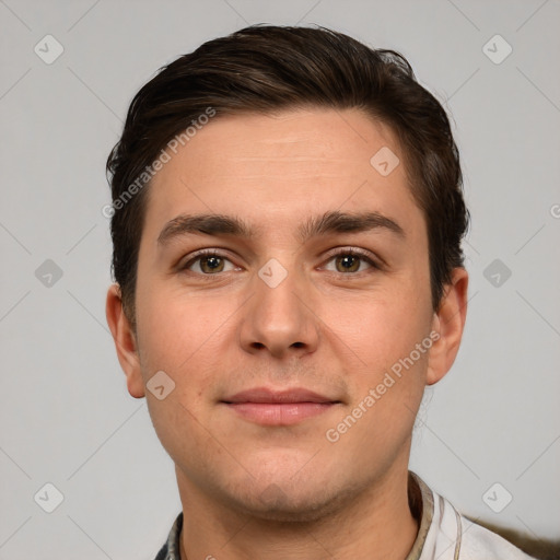 Joyful white young-adult male with short  brown hair and grey eyes