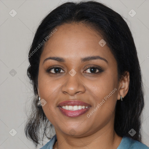 Joyful black young-adult female with long  black hair and brown eyes