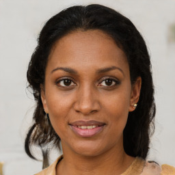 Joyful black young-adult female with medium  brown hair and brown eyes