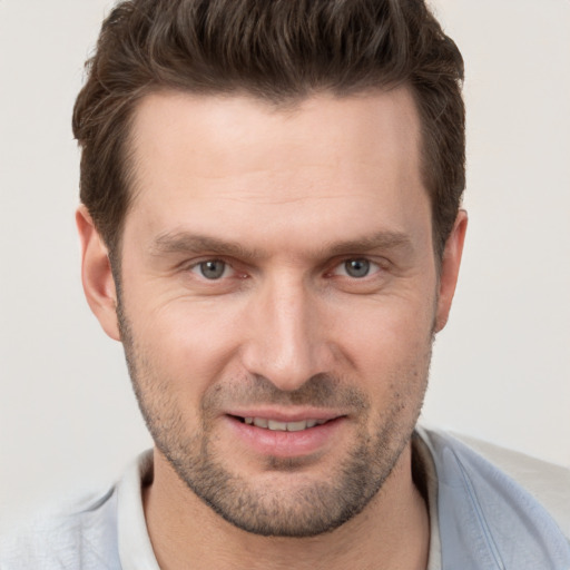 Joyful white adult male with short  brown hair and brown eyes