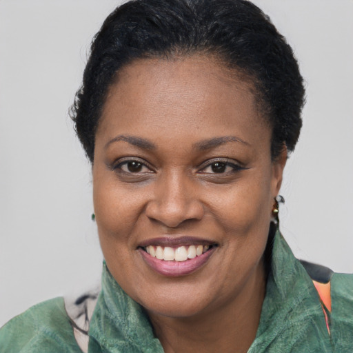 Joyful black adult female with short  brown hair and brown eyes