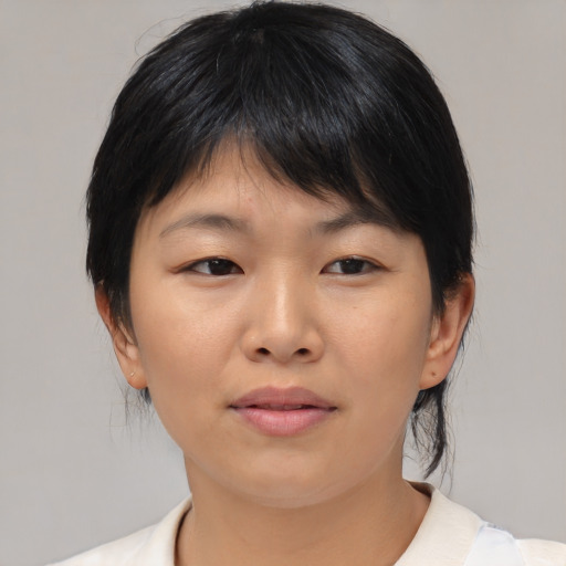 Joyful asian young-adult female with medium  brown hair and brown eyes