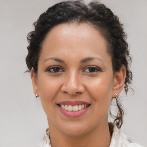 Joyful latino young-adult female with medium  brown hair and brown eyes