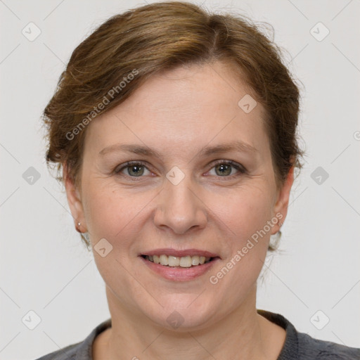 Joyful white adult female with medium  brown hair and grey eyes