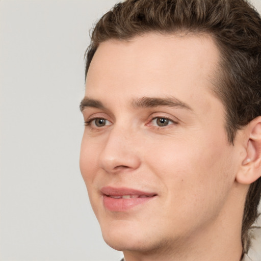 Joyful white young-adult male with medium  brown hair and brown eyes