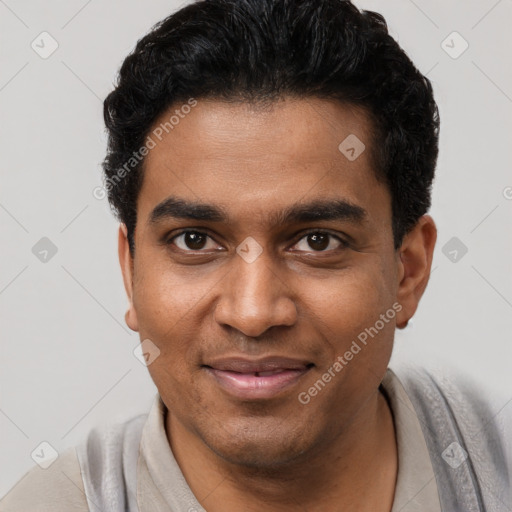 Joyful black young-adult male with short  black hair and brown eyes